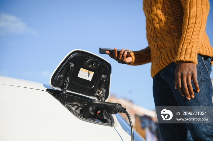 Man turning on charging of car