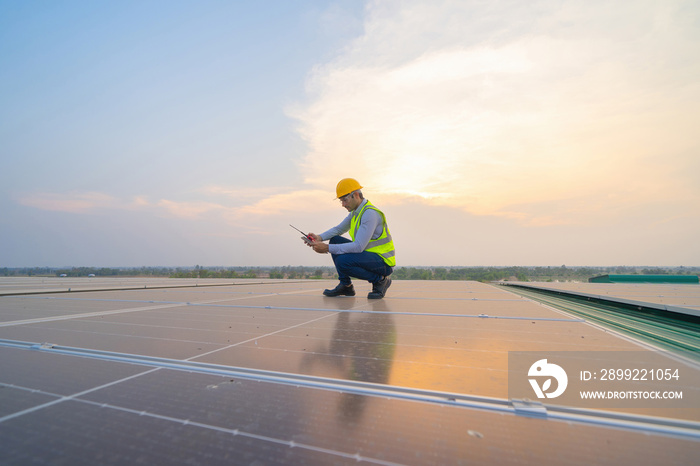 Portrait of engineer man or worker, people, working on solar panels or solar cells on the roof in factory industry. Power plant, renewable energy source. Eco technology for electric power. Maintenance