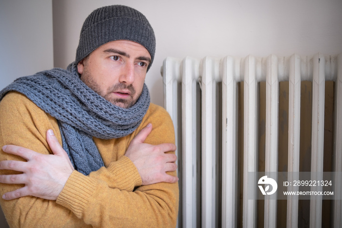 One man suffering cold at home and problem with house heating