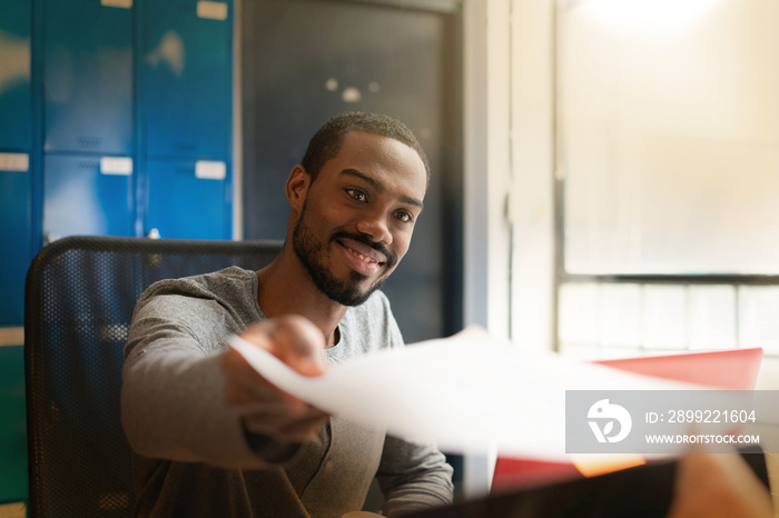 Attractive young black man working in modern office space