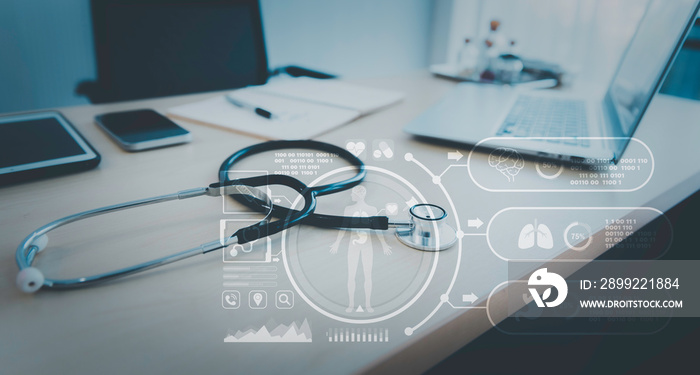 Stethoscope with computer laptop on doctor desk at hospital clinic with hologram futuristic graphic, Digital healthcare technology concept