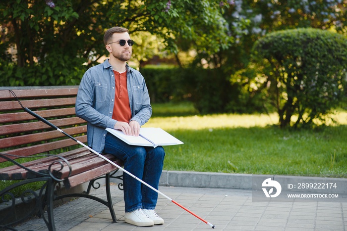 Blinded man reading by touching braille book