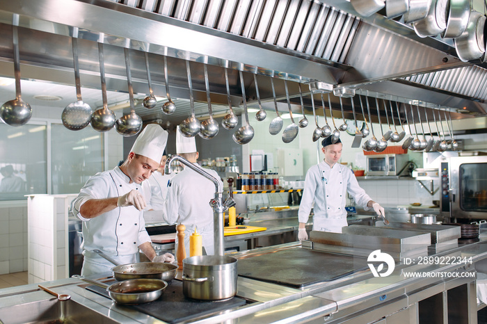 Modern kitchen. The chefs prepare meals in the restaurant’s kitchen.