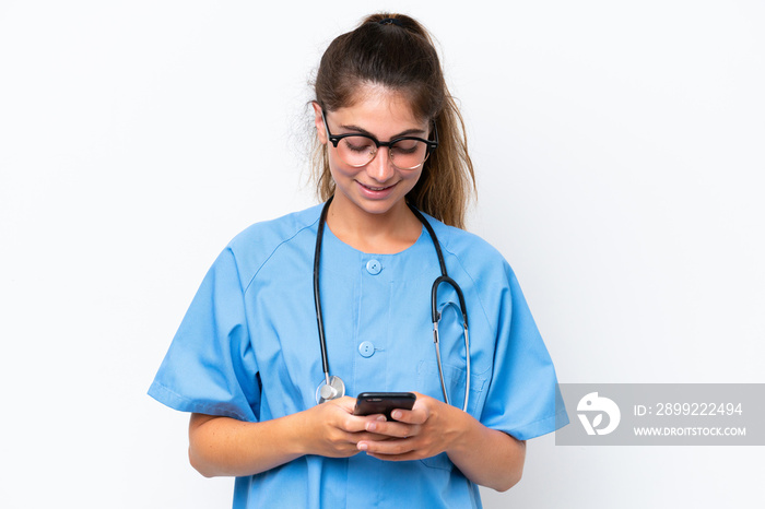 Young nurse doctor woman isolated on white background sending a message with the mobile