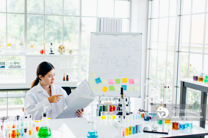 Positive delighted female scientist doing experiment