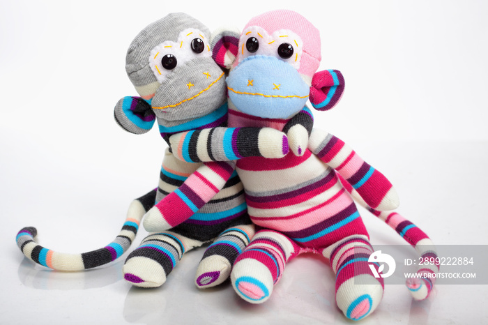 Monkey sock toys isolated on white background. Giving a hug. Ful