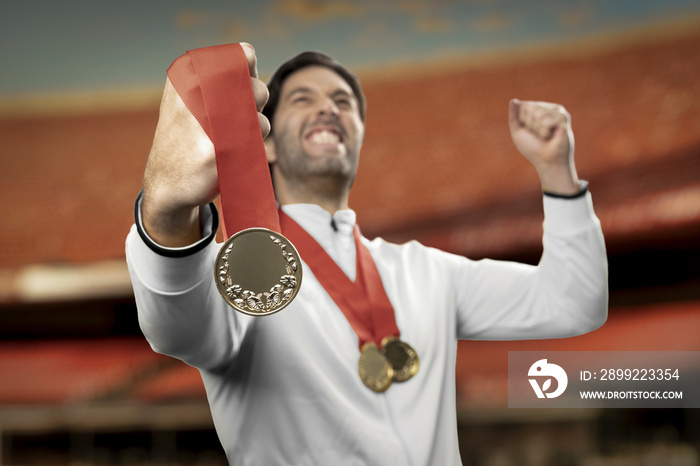 American  male athlete smiling after winning a gold medal in a white background