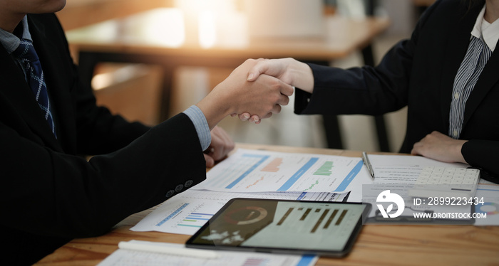 Two business people shake hands after accepting a business proposal together, a handshake is a universal homage, often used in greeting or congratulations.