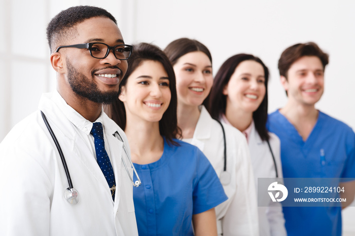 African Doctor Standing In Row With Team