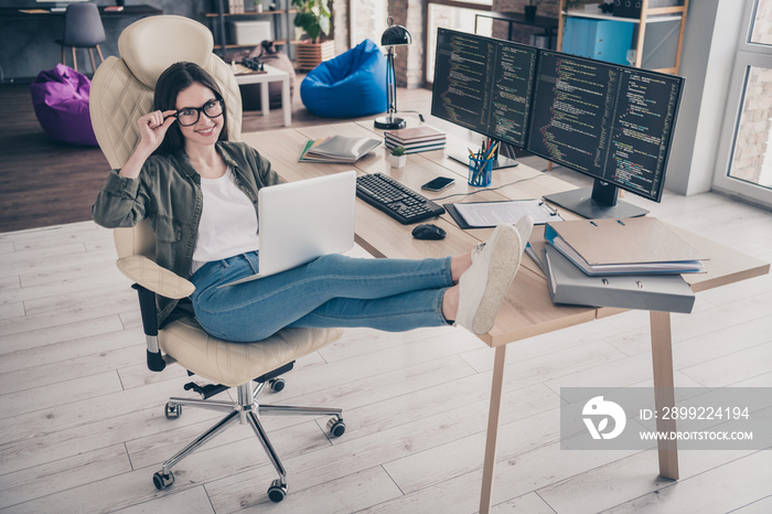 Full length photo of young cheerful girl sit stool open space use laptop designer tester workstation eyewear indoors