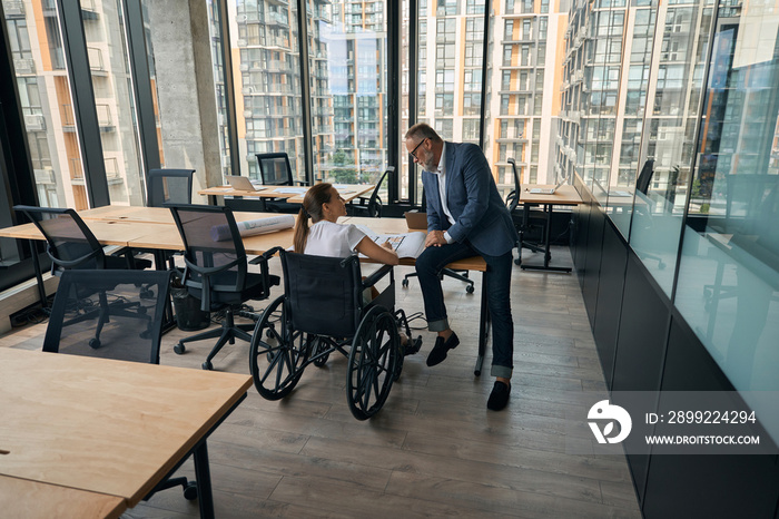 Man and woman with disability working tohether in office