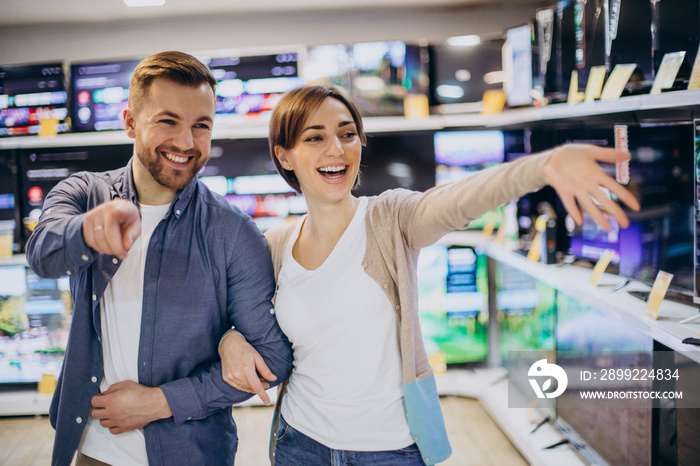 Couple choosing television at store