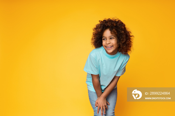 Cute african-american girl posing over studio background