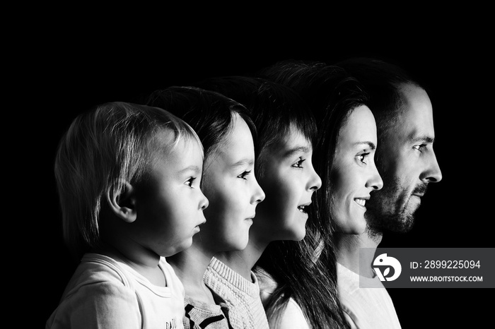 Family portrait of father, mother and three boys, profile picture of them all in a row, isolated on black background