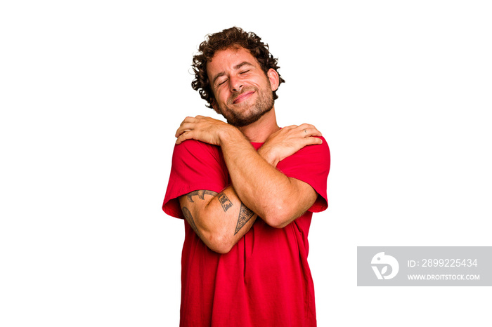 Young caucasian curly hair man isolated Young caucasian man with curly hair isolated hugs, smiling carefree and happy.