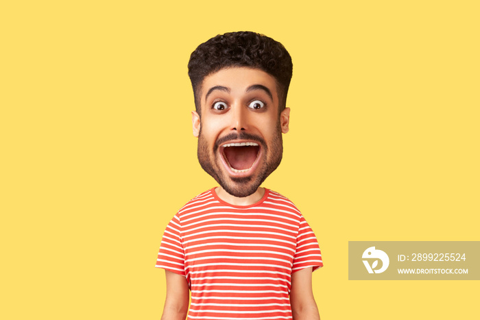 Caricature comic portrait of surprised funny young adult man looking at camera with open mouth and amazed big eyes, expressing astonishment. Indoor studio shot isolated on yellow background