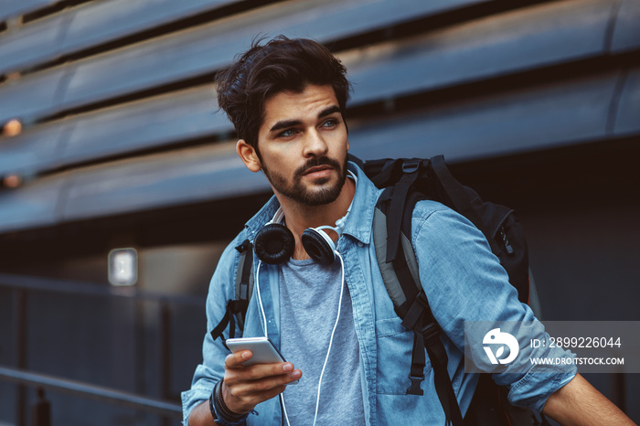 Young handsome man using smartphone outdoor