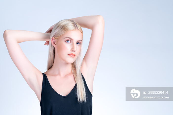 Personable woman lifting her armpit showing hairless hygiene underarm as beauty posing for cleanliness and perfect smooth skincare treatment in isolated background. Hair removal and epilation concept.