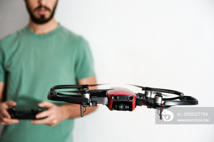 man or boy having fun flying drones inside his house during the COVID confinement