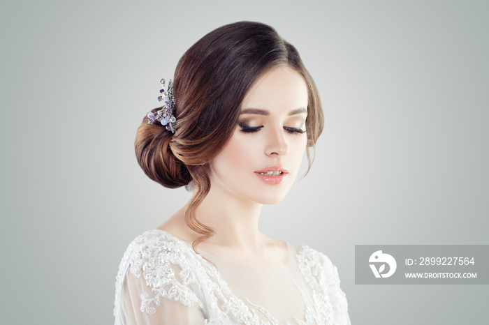 Romantic woman with bridal updo hair. Female face closeup