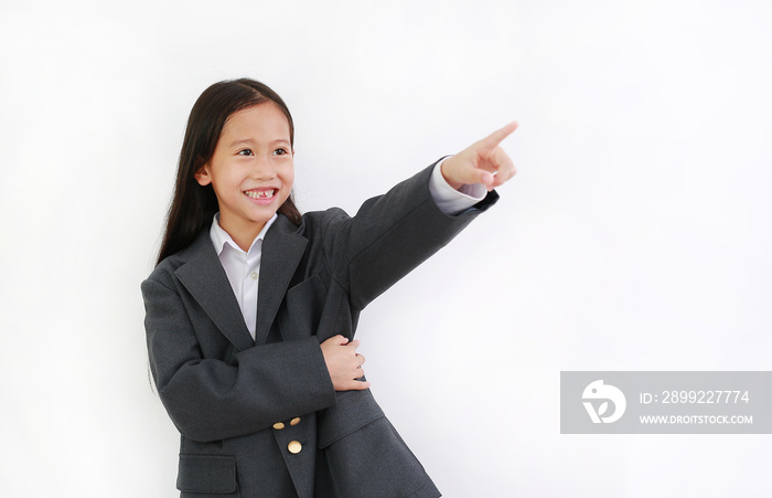 Smiling Asian little girl kid wear business suit and pointing up isolated on white background.