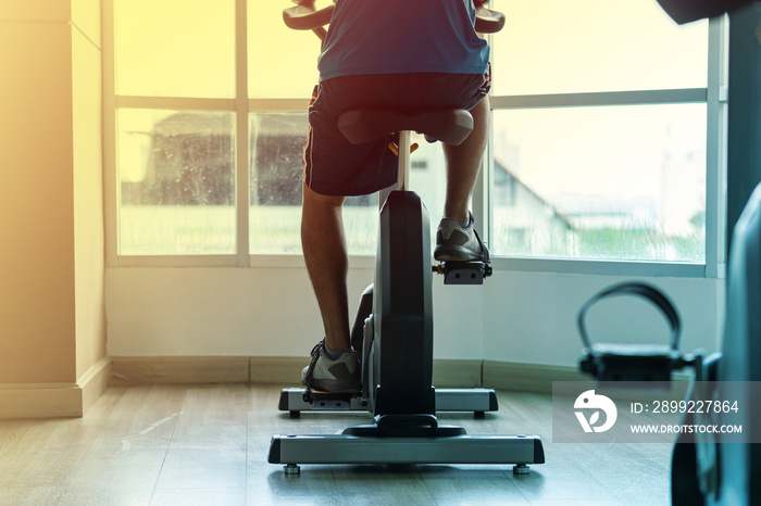 Close up of a man exercise in gym, Cycling on bike in fitness gym