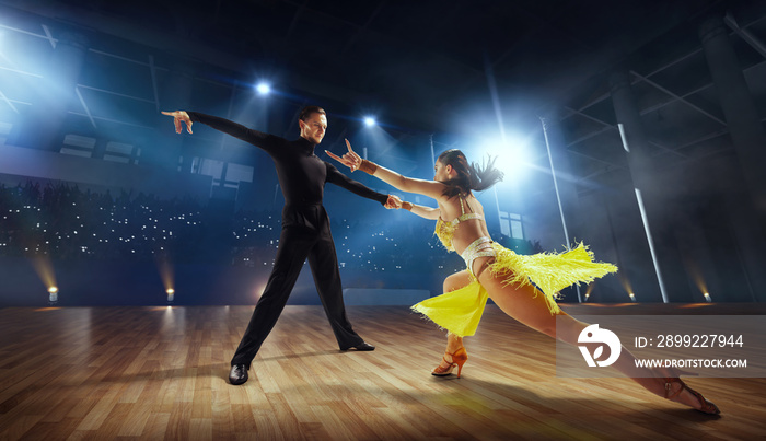 Couple dancers  perform latin dance on large professional stage. Ballroom dancing.