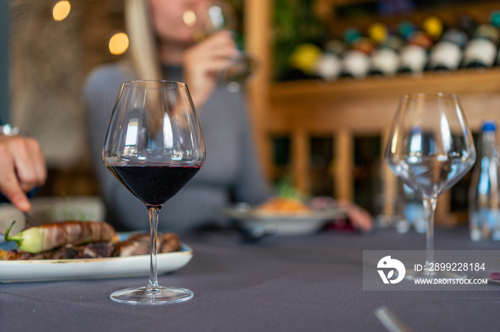 Glass of red vine on table in restaurant isolated