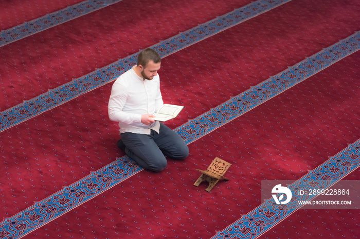 Religious muslim man praying inside the beautiful big mosque, re