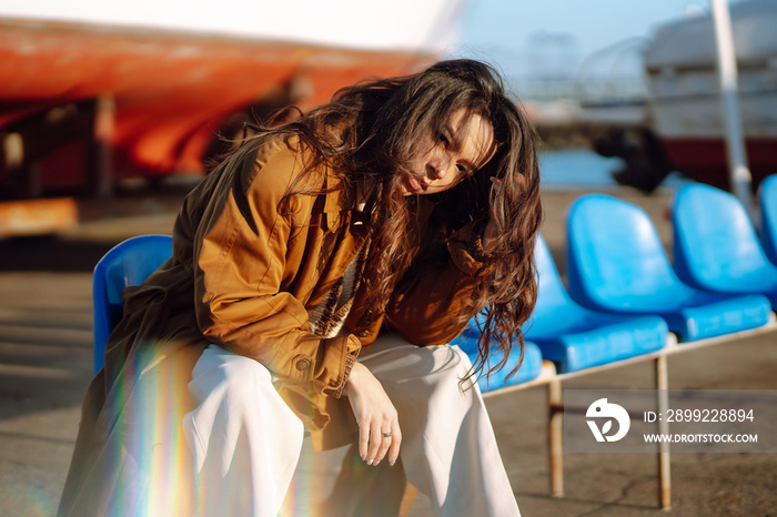 Stylish woman enjoying autumn weather outdoor. Fashion, style concept. People, lifestyle, relaxation and vacations concept.