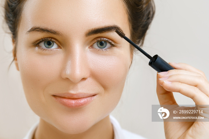 Woman applying tinted eyebrow gel