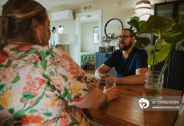 woman and man talk across table