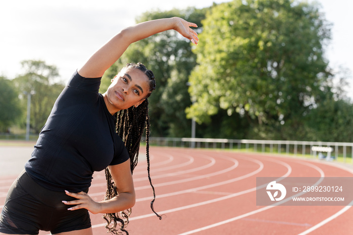 Female athlete exercising at sports track