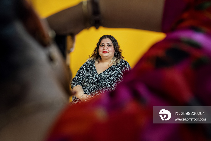 Plus sized female getting her headshots taken by a south asian female photographer