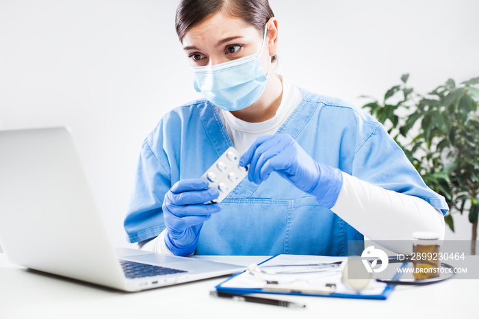 Young female doctor or pharmacist prescribing medication to patient via internet call