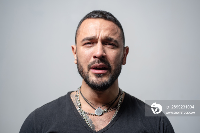 Sad face of young guy. Man cry with tears. Closeup portrait of a crying man. Emotional cry man, upset guy. Pensive guy feeling stress. Lonely frustration man.