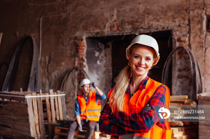 Young woman in a warehouse is smiling at the camera