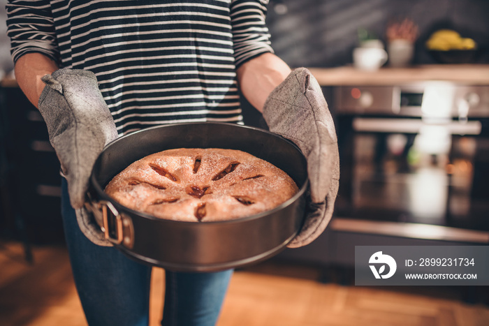 Woman holding freshly baked apple pie