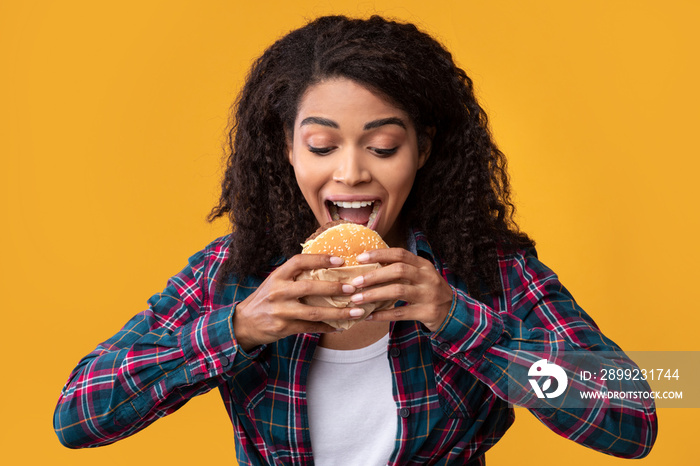 Closeup Of Funny Black Lady Eating Burger At Studio