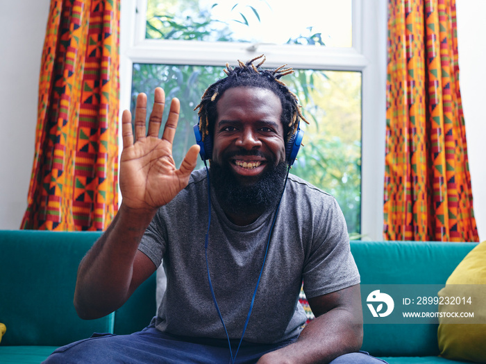 Portrait of man listening to music on headphones