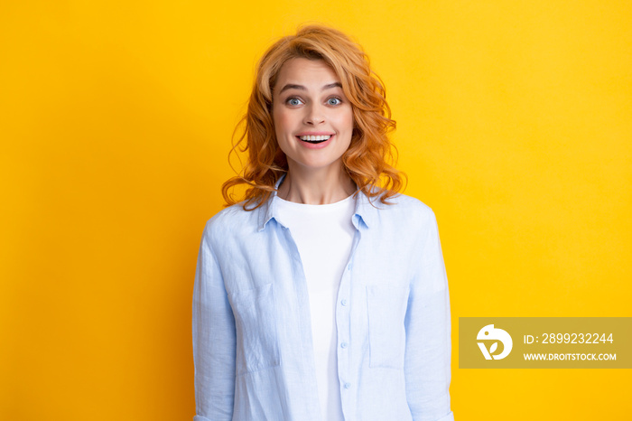 Happy smiling woman portrait. Attractive young pretty cheerful girl in casual clothing feeling happy and carefree, isolated yellow background. Happiness woman face.