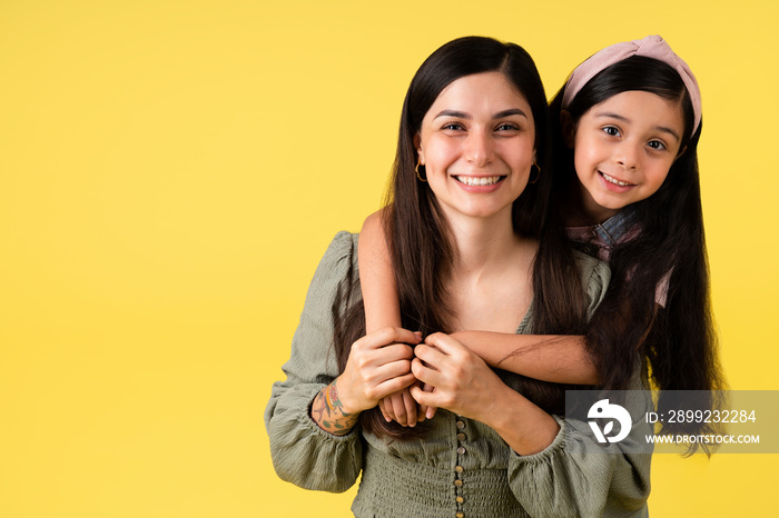 Adorable daughter embracing her mother