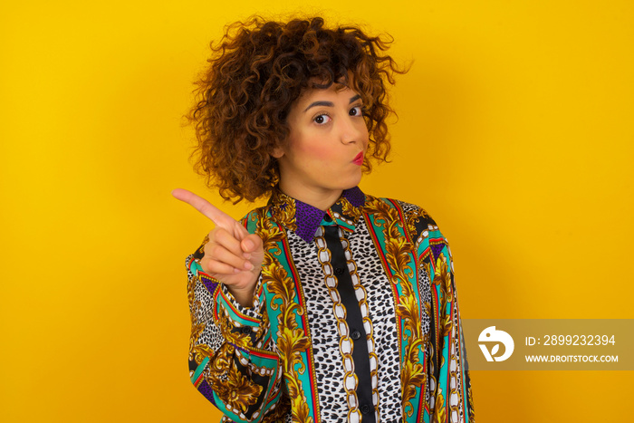 Woman gesturing a no sign. Closeup portrait unhappy, serious girl raising finger up saying: oh no you did not do that. Standing over yellow background. Negative emotions facial expressions, feelings.