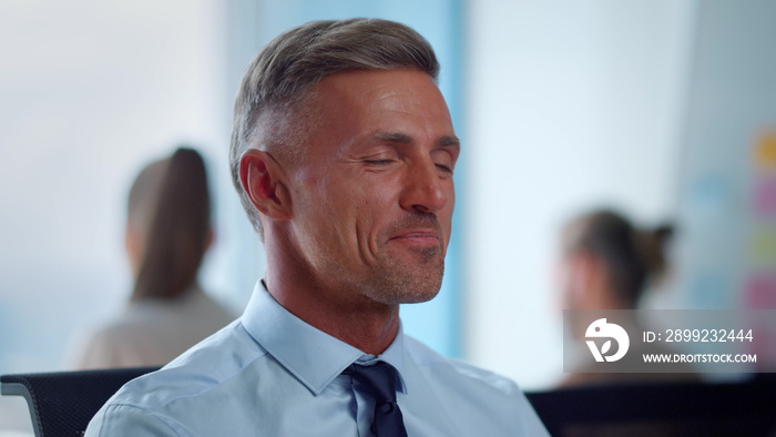 Laughing businessman showing thumbs up at video call. Happy man talking online