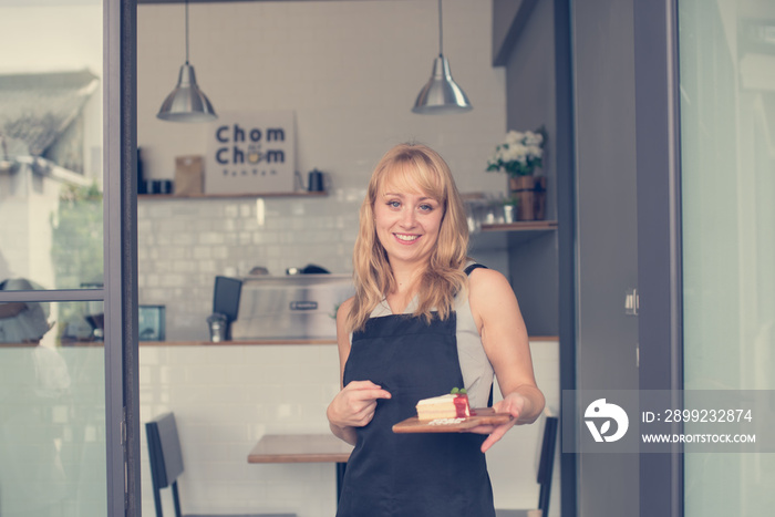 Small business owner professional sitting on chair in front of cafe and smiling for service costomer on background of cafe and resturant ,Small business sucessful concept.