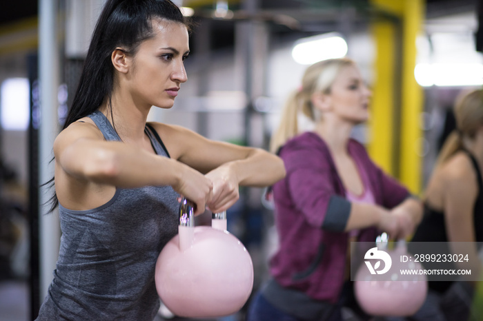 athletes doing exercises with kettlebells