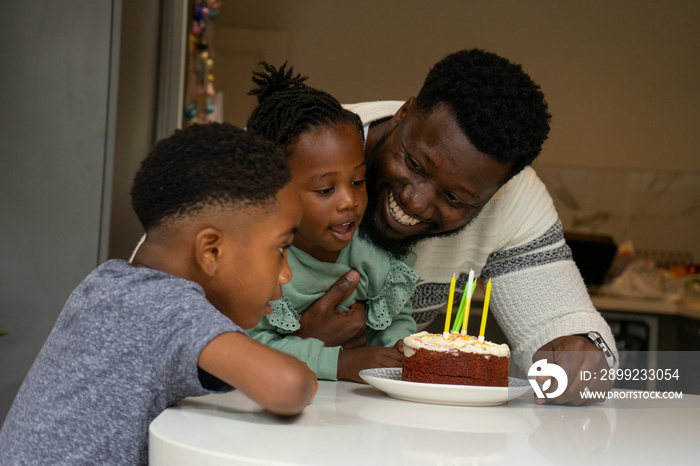 Father and children (2-3, 6-7) celebrating birthday