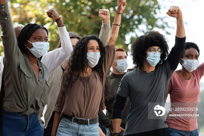 Angry demonstrators in face masks protesting on the street