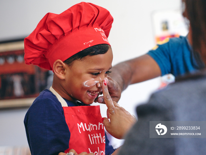 Playful parents and son baking in kitchen