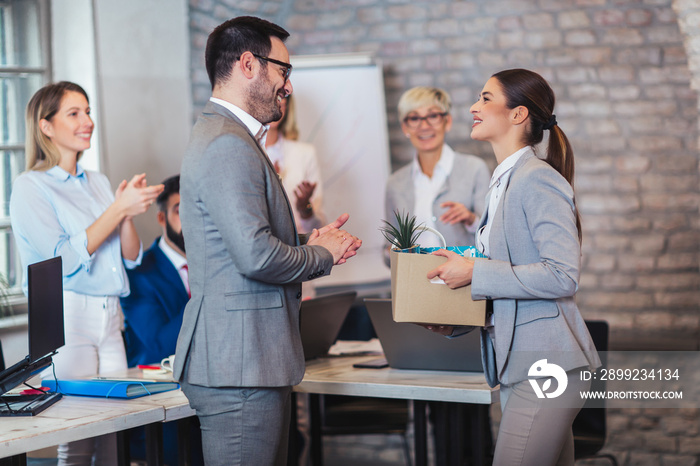 Smiling team leader executive introducing new just hired female employee to colleagues.